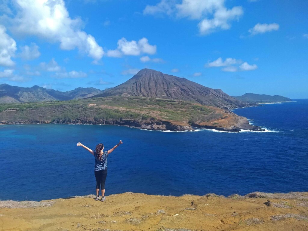 Happy hikers hiking on trail hike in beach hawaii travel. young